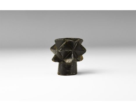 12th-15th century AD. A bronze macehead comprising a flared socket with three rows of lozengiform spikes.   198 grams, 49mm (