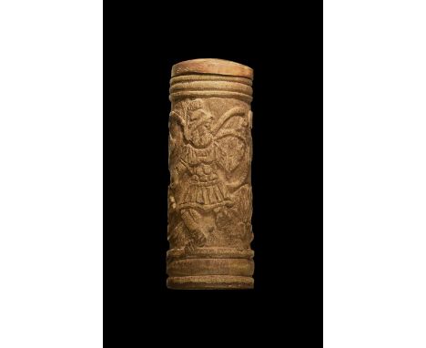 4th-5th century AD. A tubular bone pyxis carved with a running Roman soldier in uniform and helmet, looking back to a scrolli