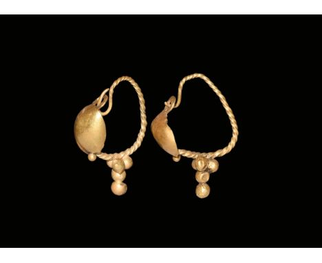 2nd century AD. A matched pair of gold earrings, each a twisted wire shank and ovoid domed plaque with granule, pyramid of ho