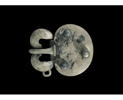 6th century AD. A large silver buckle comprising a hollow cast loop, plate and tongue; the loop hollow, formed as a w-shaped 