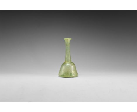 1st century AD. A pale green flask with indented bottom, conical body and tapering neck; the rim everted.   40 grams, 10.5cm 