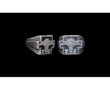 Early 20th century AD. A silver-coloured metal ring comprising a D-section hoop with flanges to the shoulders and large squar
