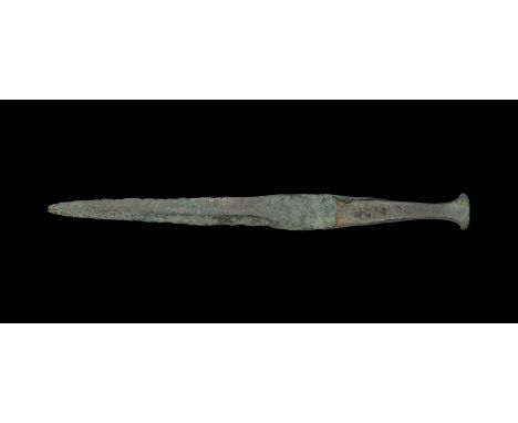 2nd millennium BC. A large slender bronze dagger with leaf-shaped blade, flat-section grip with flange to each face to accept