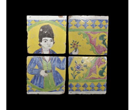 19th century AD. A group of four glazed ceramic tiles combined, with yellow field and arabesque floral borders, standing male