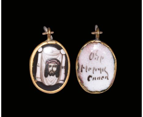 18th century AD. A discoid bifacial pendant with gold frame and hoop, two links, enamelled image to the obverse of a fabric c