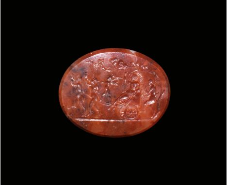 18th century AD. An oval finely carved dark red agate intaglio with a scene of a god seated in a wagon, most likely Dionysus 
