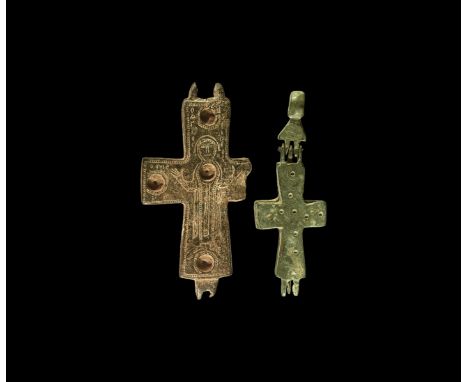 8th-10th century AD. A mixed group of bronze reliquary crosses comprising: an enkolpion with ring-and-dot detailing, hinged u