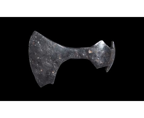 9th-11th century AD. A hand-forged iron axehead with swept upper face to the gently curved blade, square chin with rear spur,