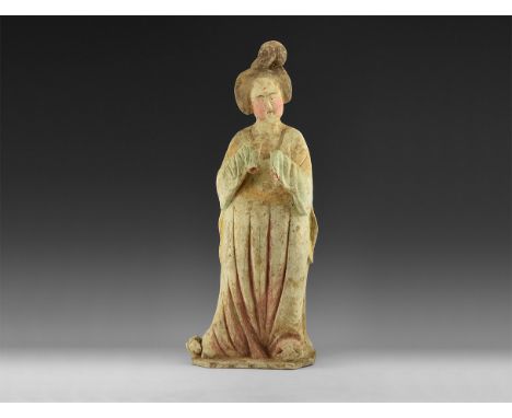 Tang Dynasty, 618-907 AD, or later. A hollow-formed ceramic statuette of a courtly lady in draped robe with neatly dressed ha