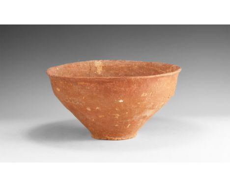 3rd-2nd millennium BC. A large bell-shaped ceramic bowl with narrow base and flared rim, three small ridged ledges to the sho