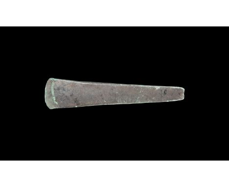 Late 3rd millennium BC. An Early Bronze Age copper flat axe of rectangular section, expanding from a narrow squared butt to s