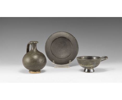 5th-3rd century BC. A mixed blackware ceramic group comprising: a footed plate with raised rim; a lekythos with strap handle;
