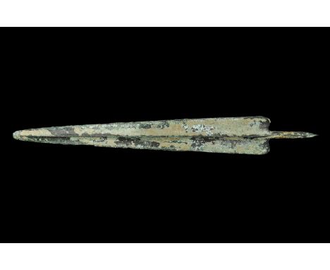 14th-10th century BC. A large triangular Bronze Age spearhead with rounded tip, median ridge and round-section tang, rounded 