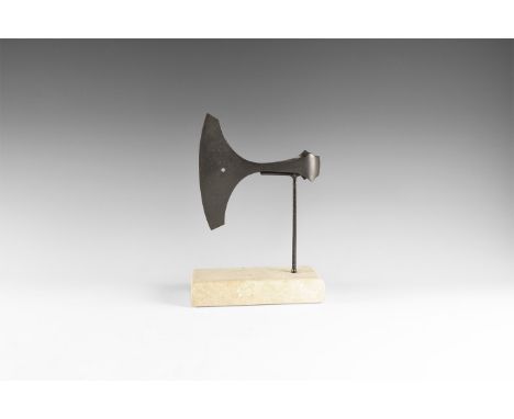9th-12th century AD. An iron axehead with broad curved edge, blade pierced at the centre, slender neck, round socket with lat