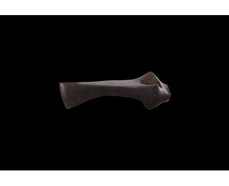 9th-12th century AD. An iron axehead with long narrow blade flared from the mid-point to a gently curved edge, lateral wings 