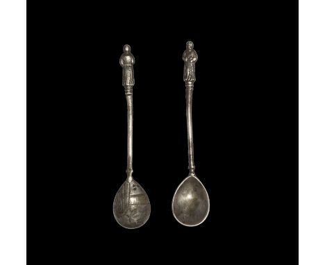 2nd millennium BC. A small silver spoon with shallow piriform bowl, round-section shank, ribbed collar with standing robed fi