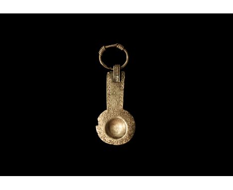 8th-11th century AD. A silver miniature spoon with with small deep bowl and wide rim punched with a series of dots; wide hand
