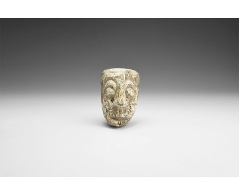Pliocene Period, 5.2 - 2.5 million years BP. A Mastodon fossil tusk face carving from Java.   33 grams, 57mm (3 1/4"). From a
