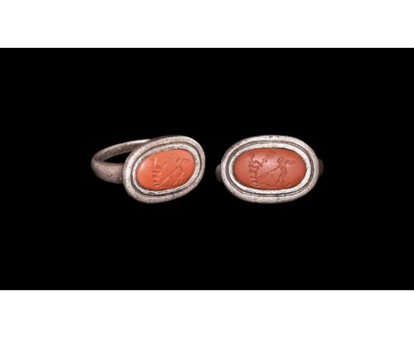 Late 1st to early 2nd century AD. A silver ring with D-sectioned shank widening to the shoulder; oval bezel set with a glass 
