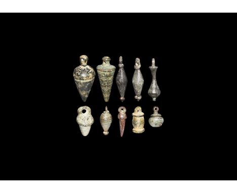 1st-4th century AD. A group of bronze plumb bob weights, each with a suspension loop and five with a conical shape, one drum-