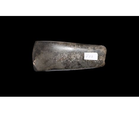 Neolithic, 5th-3rd millennium BC. A polished epidiorite axehead with flared shank, gently curved chamfered blade, narrow butt