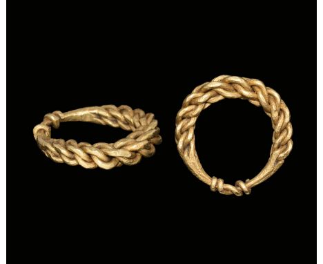 9th-11th century AD. A hoop of four expanding rods plaited, looped to the reverse and the ends wound about the shank.   13 gr
