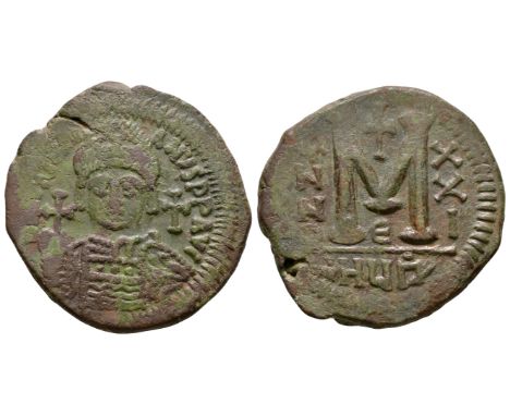 527-565 AD. Antioch mint. Obv: DN IVSTINIANVS PP AVG legend with helmetted, cuirassed bust facing, holding cross on globe and