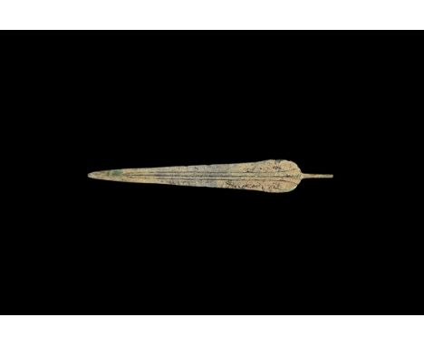 5th-3rd century BC. A bronze short-sword blade, triangular in plan with full-length ribbed midrib extending to the short roun