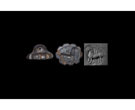 3rd-7th century AD. A discoid haematite seal matrix with dentilled edge, pierced suspension lug, intaglio griffin with segmen