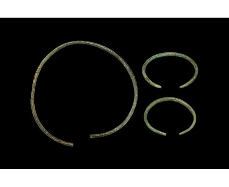 2nd-1st millennium BC. A group of bronze items consisting of two bracelets with bands of engraved lines on the body; a neck t