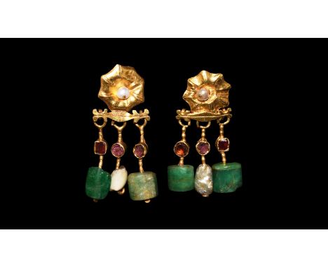 2nd-3rd century AD. A matched pair of gold earrings, each a rosette repoussé plaque with pearl to the centre and hook to the 