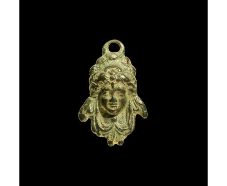 1st century BC-2nd century AD. A bronze pendant with facing bust of a bacchante (female follower of Bacchus) with swags to th