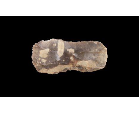 Middle Palaeolithic, 300,000-30,000 years BP. A knapped flint rectangular blade with pencilled notation '1872', old adhesive 