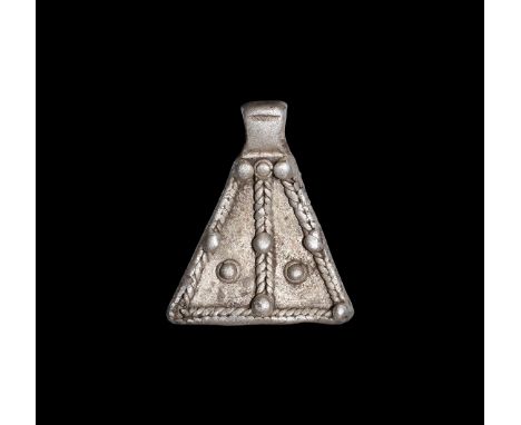8th-11th century AD. A silver axe-shaped pendant with rope wire border and central rib with pellets to the top, centre of bor