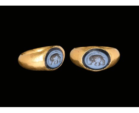 1st-2nd century AD. A hollow-formed gold hoop with expanding shoulders, inset nicolo with intaglio image of Romulus and Remus
