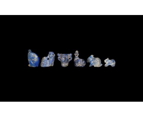 33rd-30th century BC. A group of six lapis lazuli amulets comprising: a bull's head; a rabbit; a crouching feline; a vulture;