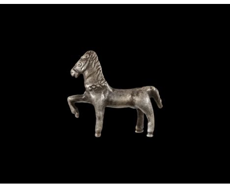 1st century BC-2nd century AD. A silver figurine of a horse with flying mane and tail, pelletted neck-band, one foreleg raise