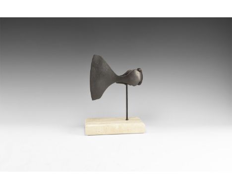 9th-12th century AD. An iron woodworking axehead with flared blade, gently curved edge, narrow neck, round socket with latera