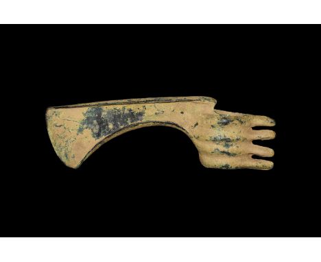 2nd millennium BC. A bronze axehead with tubular socket, four ribs extending to spikes to the rear, curved blade with flange 