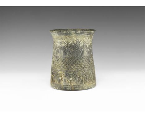 3rd millennium BC. A tall carved vessel with conical body and flared rim, decorated by two bands of palm trees and one centra