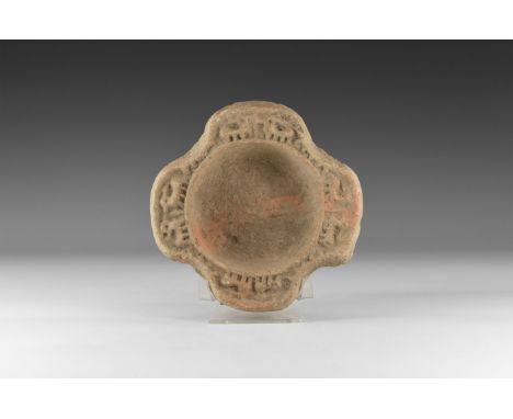 1st millennium BC. A ceramic bowl with raised rim formed as quatrefoil with each lobe decorated by quadrupeds, possibly stags