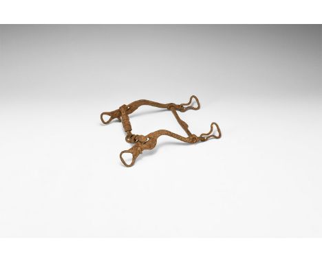 2nd century BC-1st century AD. An iron horse bit assemblage with jointed mouthpiece, shanks with looped terminals and flat-se