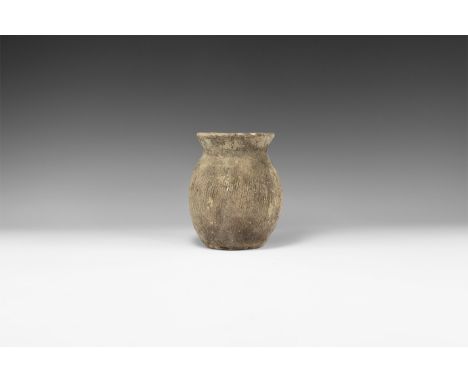 3rd millennium BC. A rounded ceramic vase with flared rim, leather texture to the body.   564 grams, 14.5cm (5 3/4"). Propert