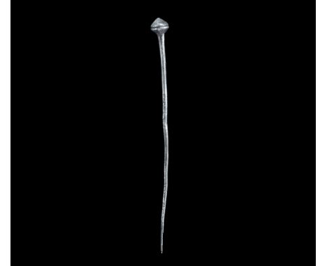10th-11th century AD. A silver hair pin with a tapering shaft connected to a ‘poppy’ terminal; the lower zone of the head pla