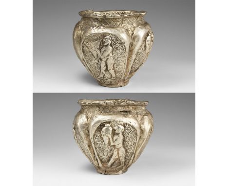 4th-3rd century BC. A silver repoussé vessel with wide, irregular shaped mouth with chevron pattern to the short neck; to the