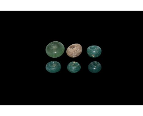 9th-12th century AD. A group of five green glass bead, and one chert spindle whorl with central perforation. Cf. Kolchin, B.A