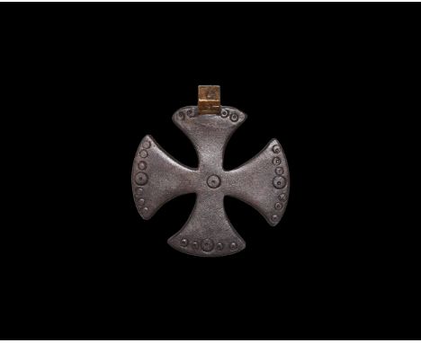 14th-15th century AD. A flat-section bronze expanding-arm cross pendant with curved outer edges, band of ring-and-dot detaili