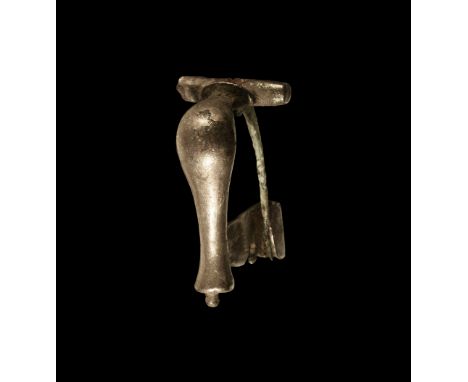 2nd century AD. A silver knee brooch with rounded piriform bow, crossbar with D-shaped stop, extended catchplate with recess 