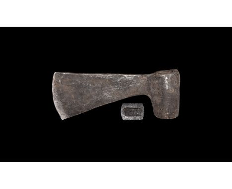 14th-15th century AD. A hand-forged iron axehead with eccentric rounded socket, flared blade with rectangular stamped maker's