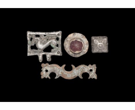 7th-9th century AD. A group of silver items comprising of a flat double-headed beast applique, a pyramid mount with a central